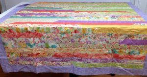 Photo of a queen sized Jelly Roll Race quilt