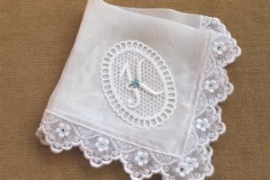 Photo of handkerchief with letter K monogrammed on top of cut work circle