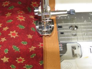 Photo f sewing invisible zipper on back of Christmas pillow