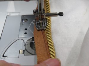 Photo of zipper foot and cording where zipper is shifting to left away from cording