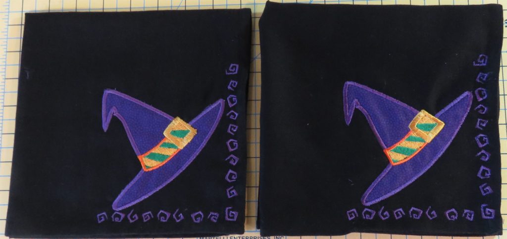 Photo of two black embroidered Halloween napkins with witch's hat dessign