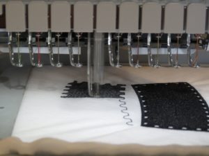 photo of hat pieces of freestanding embroidered snowman being sewn out