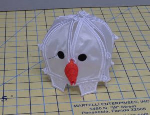 Photo of head section of freestanding embroidered snowman with all sections hooked together.