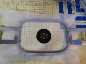 Monogrammed button cover for square tuffet