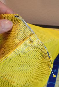 Photo of bottom corner of bag pinned for sewing 