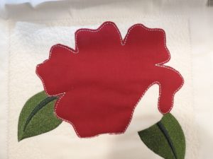 Photo of resized appliqué tacked down by embroidery machine