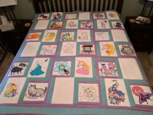 Photo of quilt made from a variety of different Anita Goodesign collections