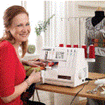 Photo of woman sitting at serger for class at Aurora