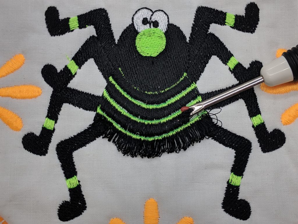 Photo of spider embroidery with loops created for fringe