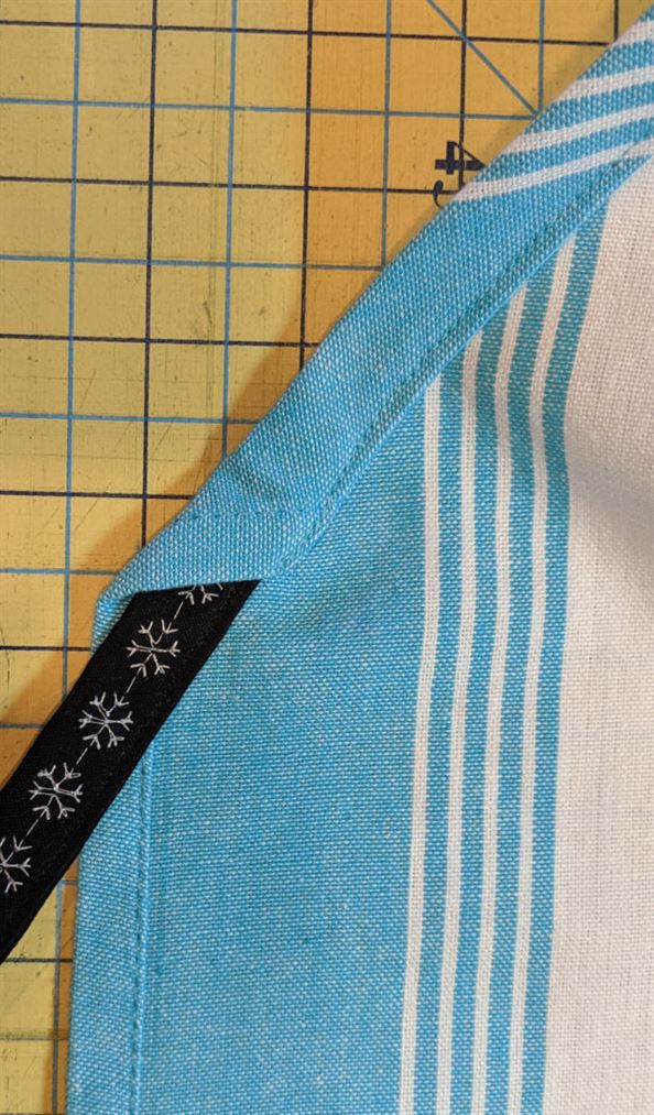 Photo of tie threaded through casing of tea towel apron