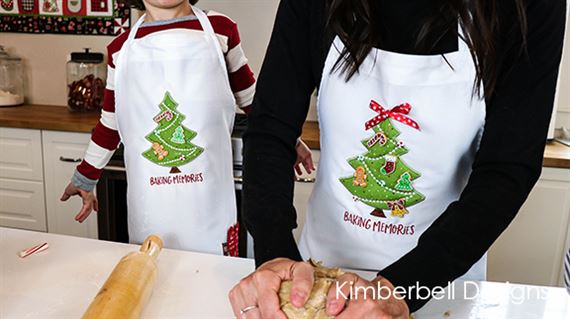 Photo of aprons made from embroidery patterns in We Whisk You a Merry Christmas from Kimberbell show in September Sew Fun