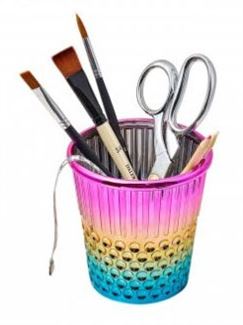 rainbow thimble holding scissors, and paintbrushes for workspace organization