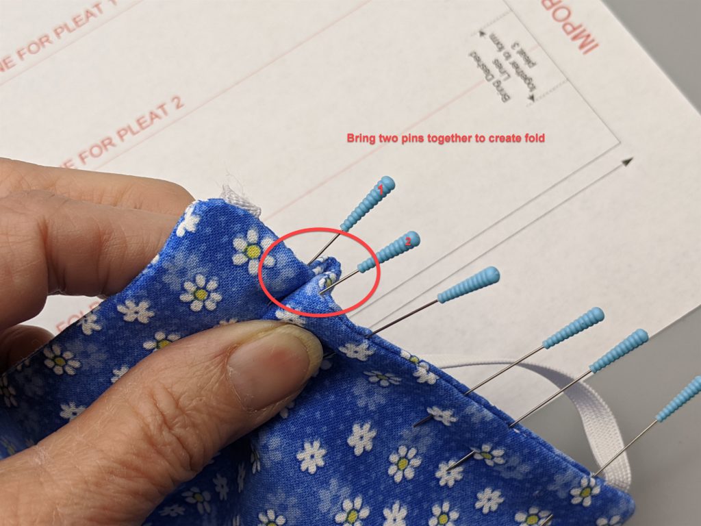 Photo of bringing two pins together to create fold