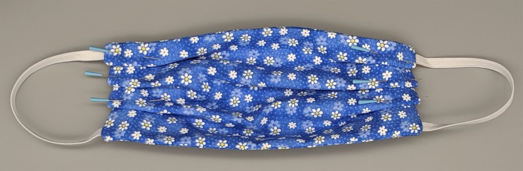 Photo of cotton face mask with all pleats pinned down