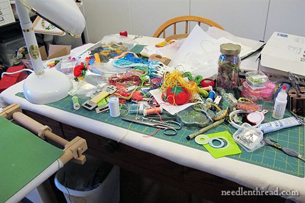 photo of cluttered cutting table  as example for workspace organization