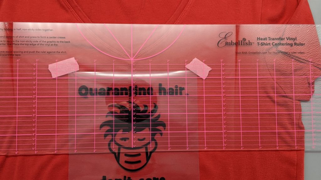 Photo of Embellish Centering Ruler to position Quarantine Hair foil design placed on shirt.