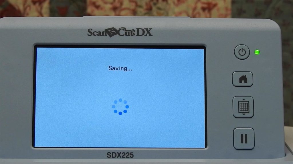 Screen shot of ScanNcut SDX225 with busy saving message