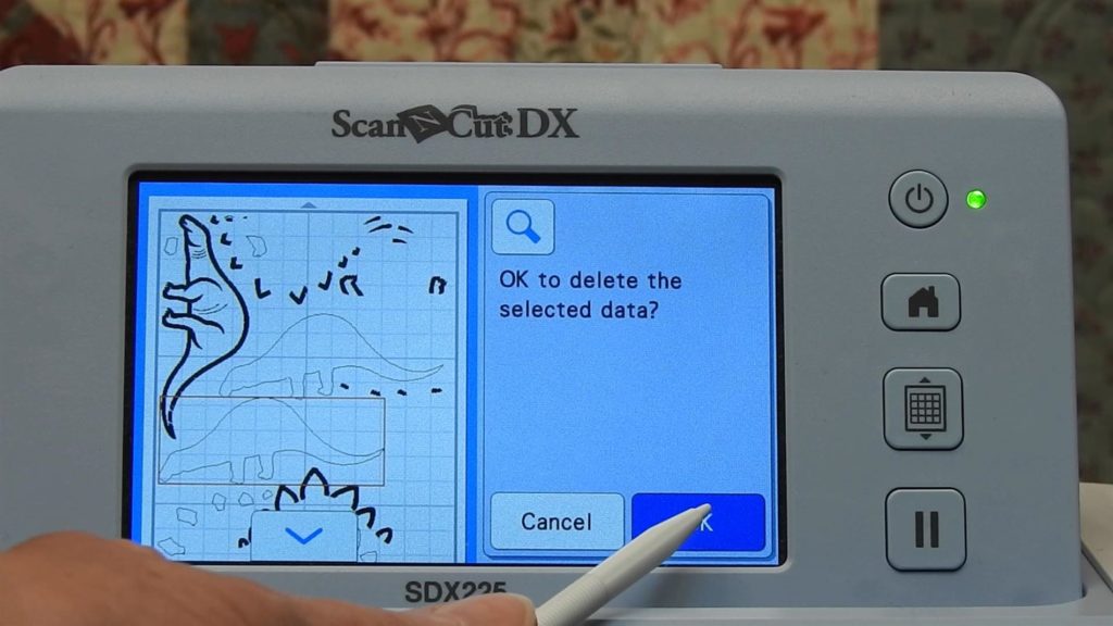 Screen shot of ScanNCut SDX225 message when deleting applique tackdown stitch for dinosaur's body
