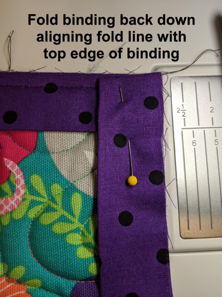 photo of corner of project showing how to fold binding to create mitered corner
