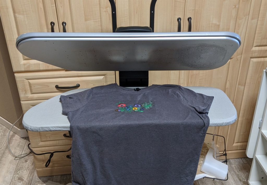 T-shirt on steam press with garden glitz design and rhinestones placed