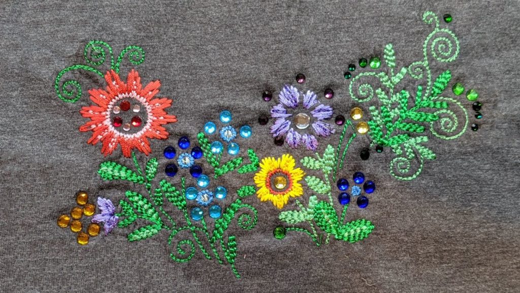 Glitz Garden embroidery design with applied rhinestones on a t-shirt.